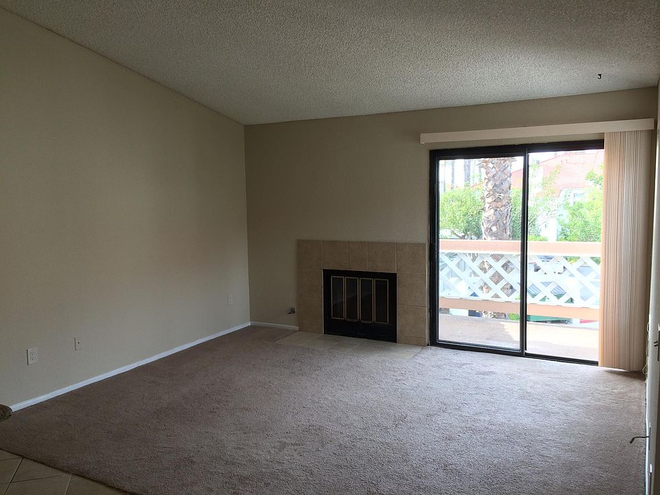 Large and bright living room with fireplace and balcony