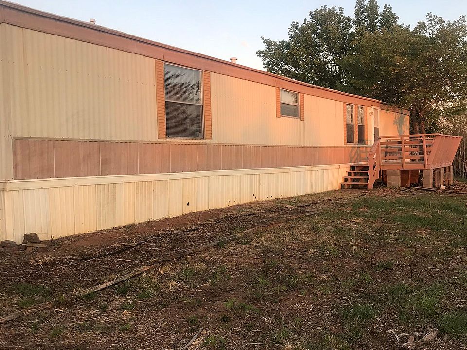 Front of home that faces mountains and hills. Still working on the property to get it nice around the home