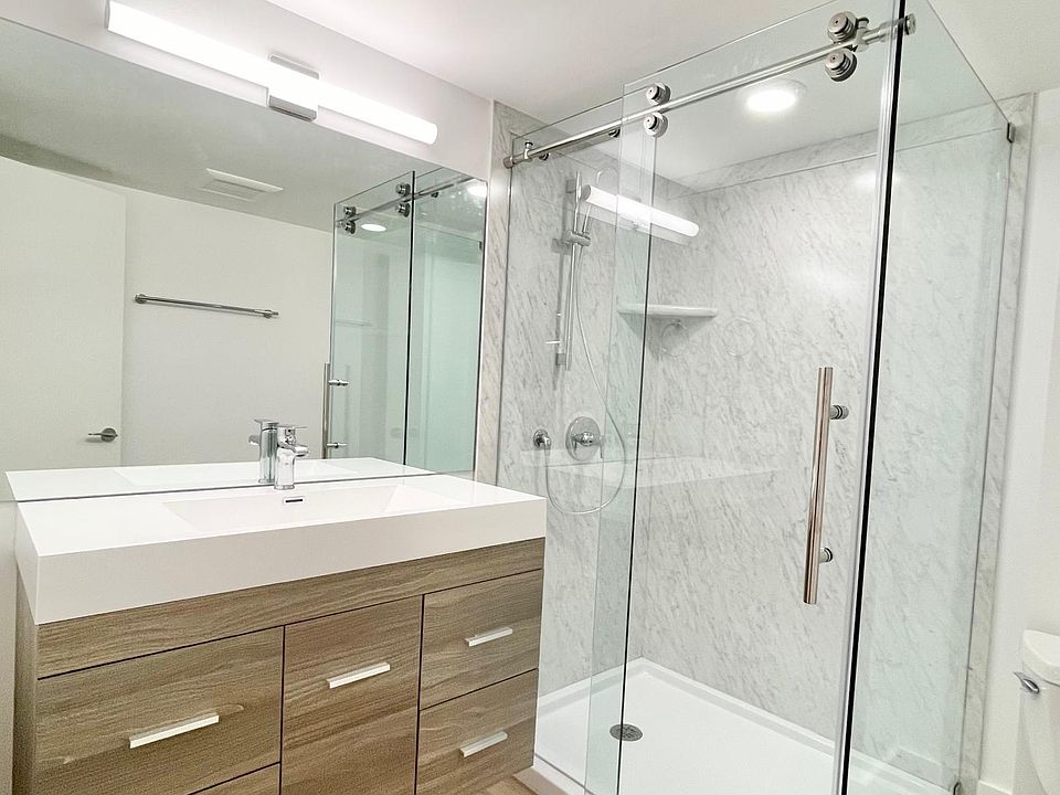 New bathroom with custom shower and solid surface top vanity