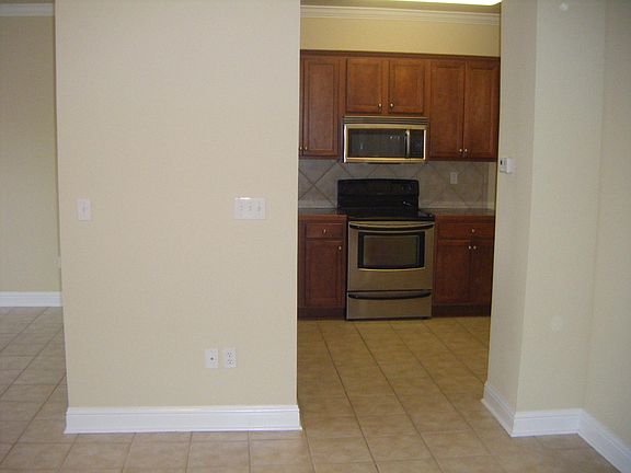 Stainless Steel Appliances - Range, Microwave/hood, Dishwasher, Sink. No refrigerator included. Large walk-in pantry. Access to garage on right.