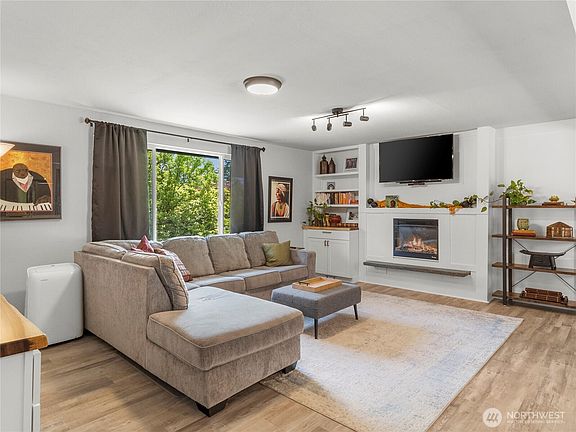 Luxe LVP throughout this South facing living room. Sunlight!>