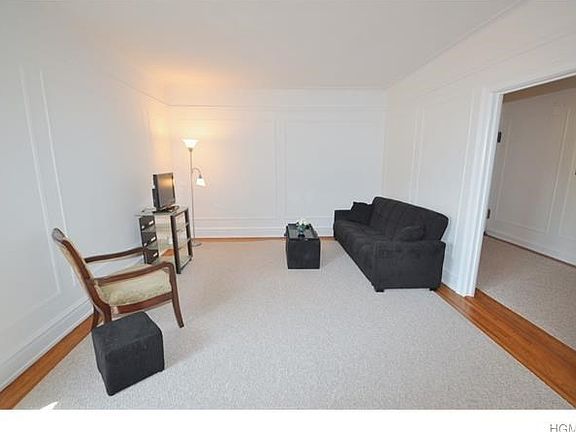 Large Living room has hardwood floors and in-laid trim.  The room has picture moldings, wall moldings and a cove ceiling.  There is a ten panel glass butler door to the eat-in-kitchen.  The room is 21'-0" x 13'-0".