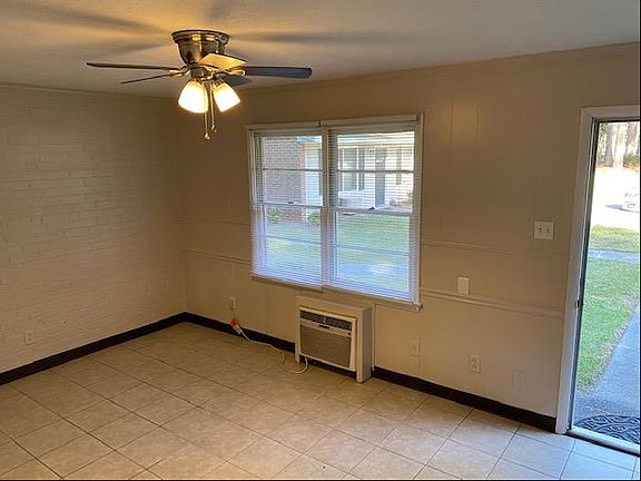 Den with Tile floor and ceiling fan