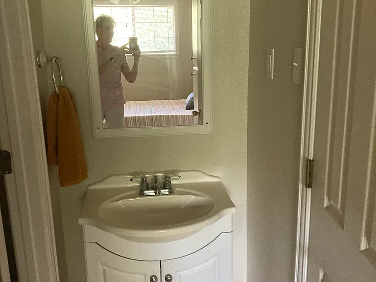 Sink with bath on one side and walk-in closet to the other side