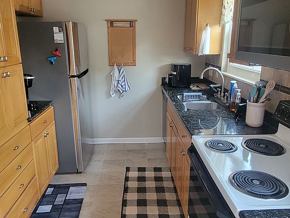 fully equipped kitchen with stainless stain appliances and granite countertop. Pots, pans, dishes, silverware, Kuerig coffee maker and air fryer included.
