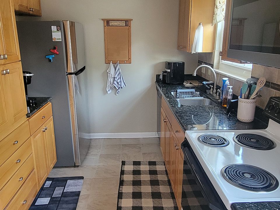 fully equipped kitchen with stainless stain appliances and granite countertop. Pots, pans, dishes, silverware, Kuerig coffee maker and air fryer included.