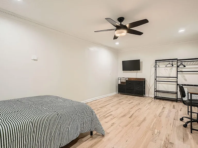 Room includes bed, desk, Smart TV, workspace and clothing storage. Linens are not provided.