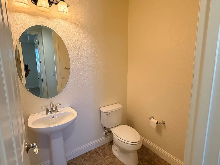 Half bath near the family room, next to stairs to the second floor