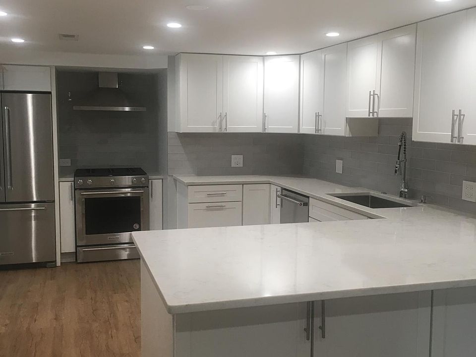 Huge quartz countertops with breakfast bar (and lots of cabinet storage)