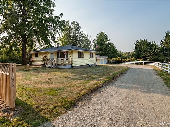 There is a long, freshly gravelled driveway (with two entrances) that loops around the house, providing both access and expansive additional parking.  The fence is freshly mended and painted.