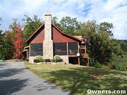 SIDEVIEW OF HOME & PORCH WITH FIREPLACE