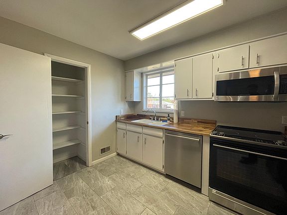 Newly installed custom butcher block countertops and pantry