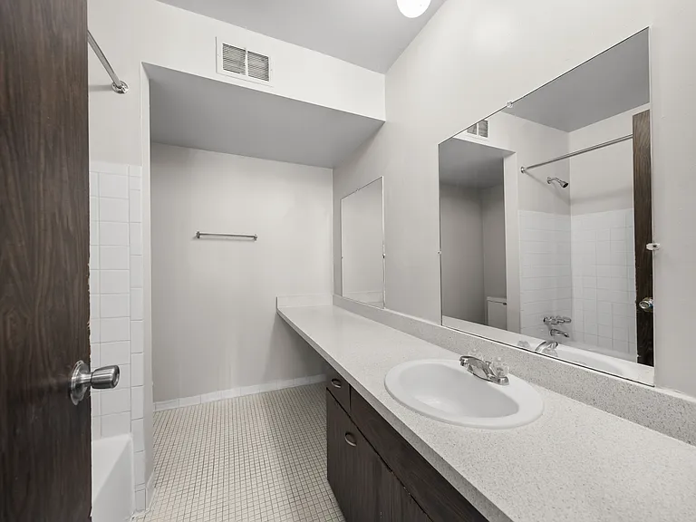 Elevated bathroom with ample storage space at Knottingham Apartments in Clinton Township, MI.
