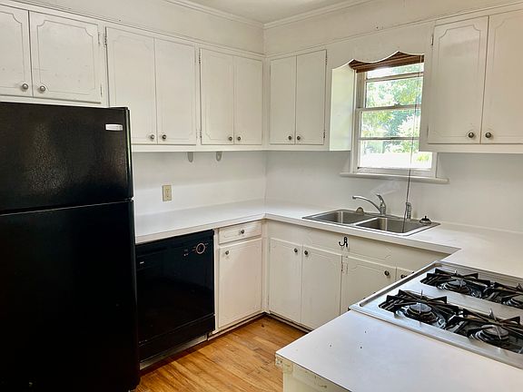 Large kitchen with a cooks delight four burner gas range. The kitchen has a view of the front yard and has direct access to the back yard.