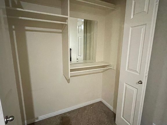 Closet in Bedroom 2 with custom mirror.