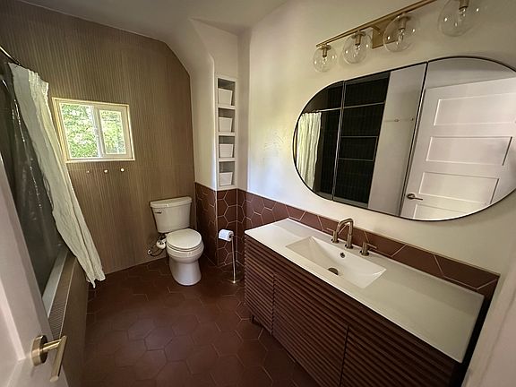 New bathroom with deep soaking tub, recessed medicine cabinet, and large linen closet