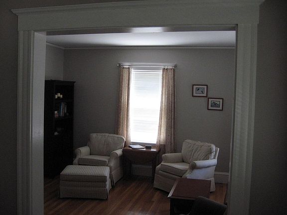 View from front entry hallway by front door into living room.