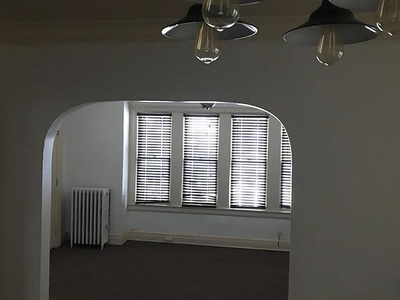 Arched dining room entry, view from dining room, carpeted.