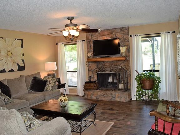 Gorgeous flooring, stone wood burning fireplace, nice views from windows looking out to deck & golf course