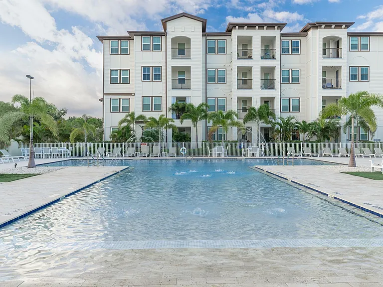Experience serene living with this luxurious apartment offering a stunning poolside view.