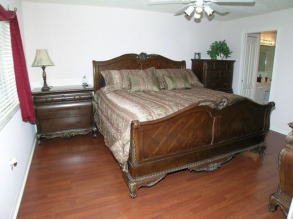 Master bedroom with wood floors and walk-in closet