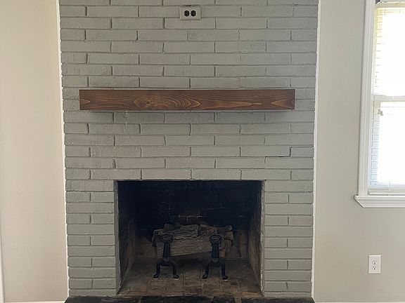 Beautiful fireplace in sitting room open to the kitchen