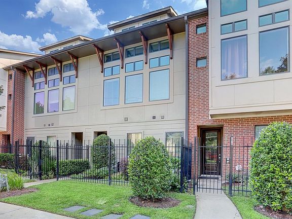 Natural light floods into this home through the wall of windows and the lovely front yard provides a beautiful entrance to the property.