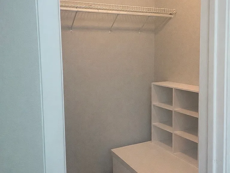 Primary bedroom small walk in closet
