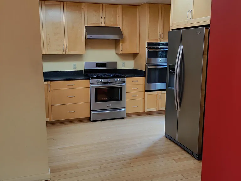 Kitchen view including refrigerator and skylight.
