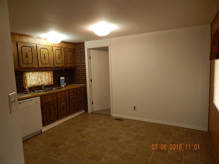 Kitchen looking to front of home - front bedroom door at rear center of photo.