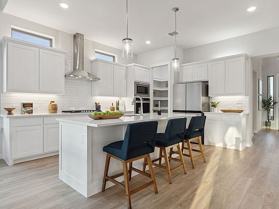 Kitchen in the Monet II home plan by Trophy Signature Homes - REPRESENTATIVE PHOTO