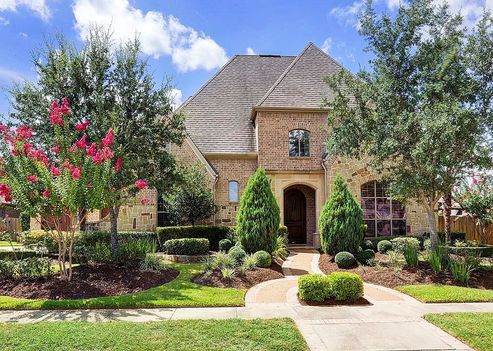 Stunning and stately, this 5 Bedroom / 4.5 Bathroom home is situated on a huge 14,000+ sq ft lot with gorgeous & extensive landscaping. A brick and stone exterior is complemented by the perfect blend of of straight lines and soaring gable roof tops.