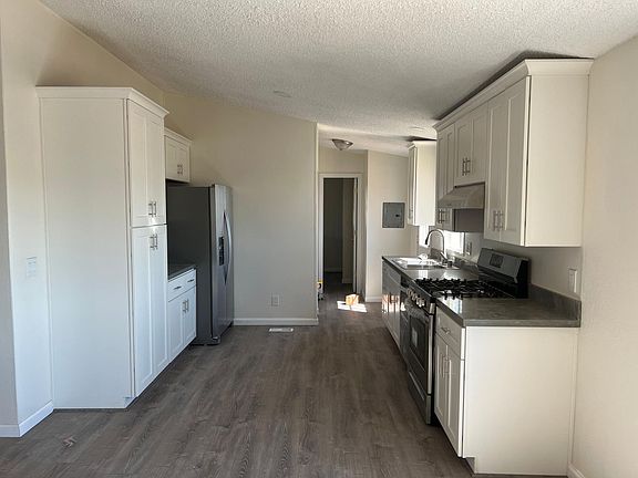 Completely remodeled kitchen with new appliances, sink, cabinets, countertops, flooring.