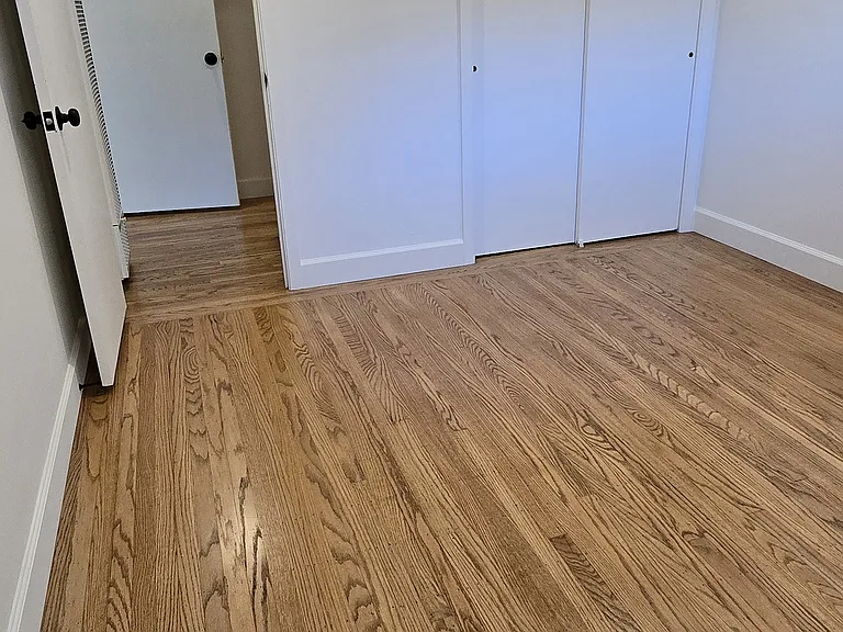 Bedroom #2 with tall baseboards and dimmable recessed lighting.