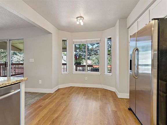 Breakfast nook in kitchen overlooking the tranquil backyard.