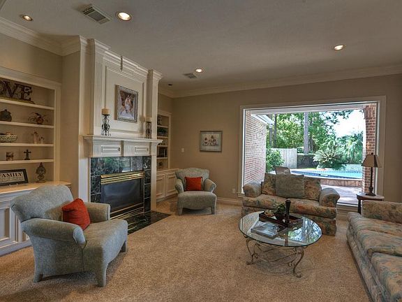 The spacious FORMAL LIVING ROOM (17 x 15) off the Foyer is great for entertaining with incredible views of the pool, covered lower terrace, and golf course. Soft neutral designer wall and carpet colors take nothing away from this view.