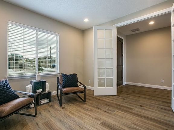 Brightly lit den with stylish French doors.