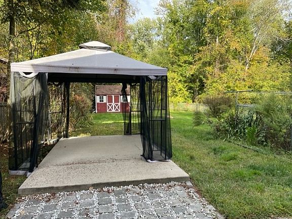 Patio with covering and shed, fenced in yard
