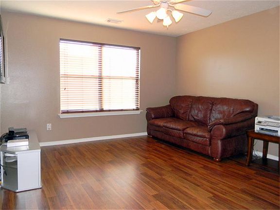 Upstairs Game or Media Room with wood floors