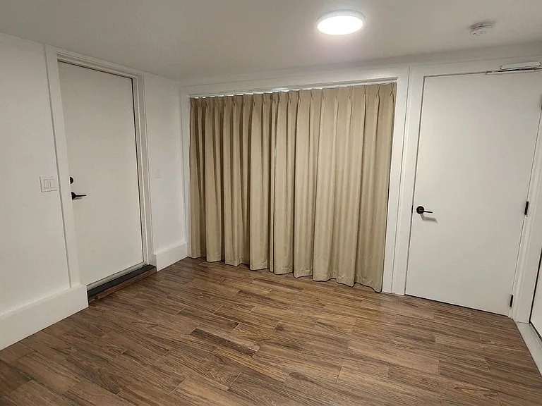 Downstairs, flexible space utility room with laundry closet, curtains closed