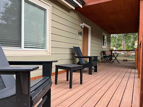 Front porch, smooth composite decking. Cedar posts and trim.