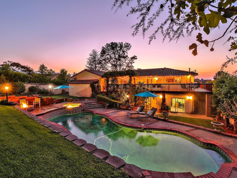 Backyard: Swimming Pool, hot tub with the fire pit aglow. This is the rear of the home facing the Los Gatos Mountains.