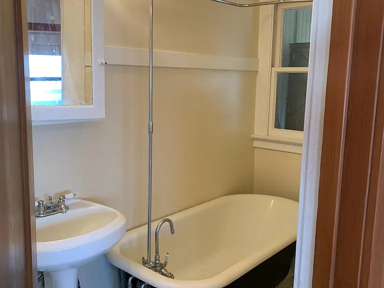 Bathroom with marble floor and claw-foot tub