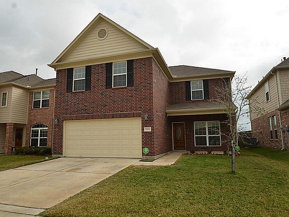 Another view of this 3000+ sq ft, red brick home with a porch perfect for relaxing and watching the sunset.