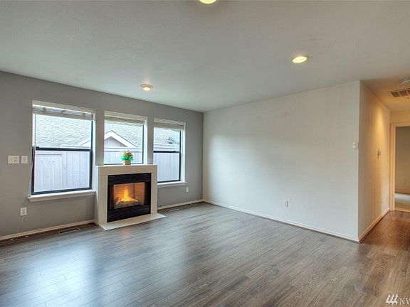 Bright formal living room with gas fireplace.