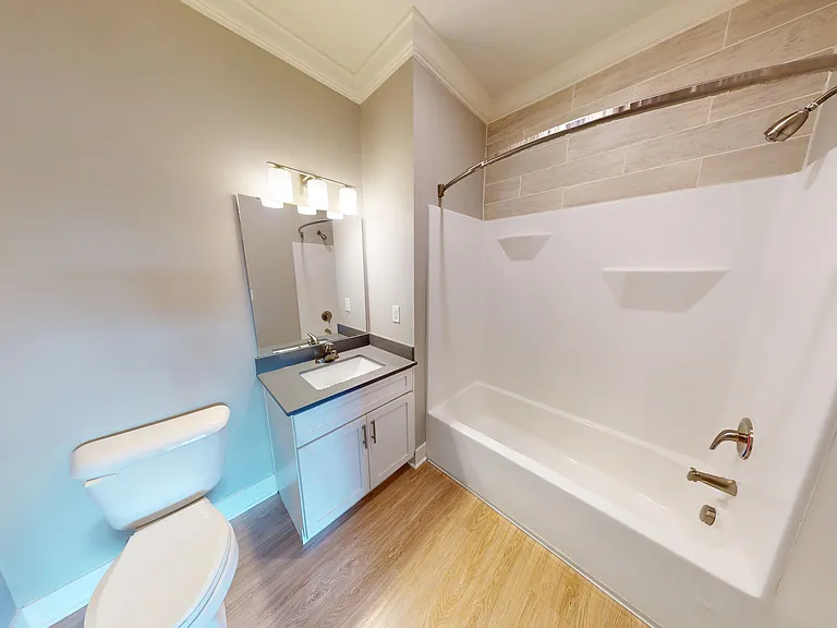 The primary en suite bathroom includes a vanity sink and shower/bathtub combo. The primary en suite bathroom includes a vanity sink and shower/bathtub combo.