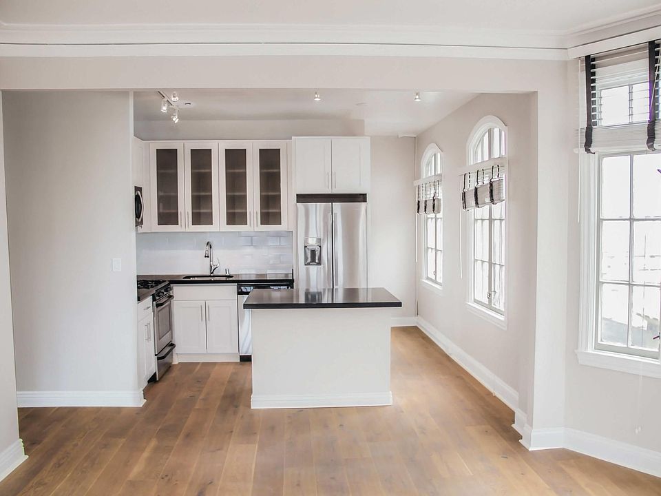 Nob Hill Place ~ Newly renovated residences! Open kitchen layout with kitchen island, elegant quartz counters, designer wood like flooring, custom white cabinetry, stainless steel appliances, dishwasher, built in microwave, gas stove, track lighting, nat