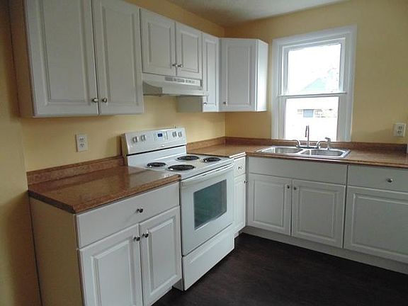 kitchen with backdoor to tiny fenced yard