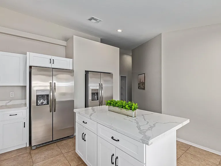 Two sets of stainless steel fridges. Each room has marked space to use in each fridge.