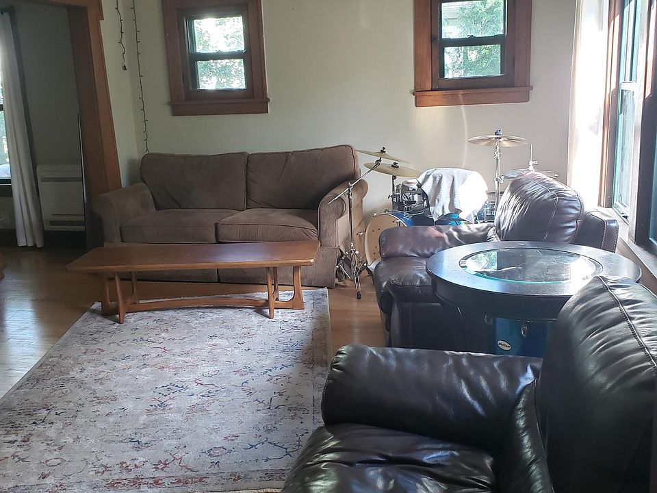 Large, South-facing Living Room. Original wood floors and trim.
